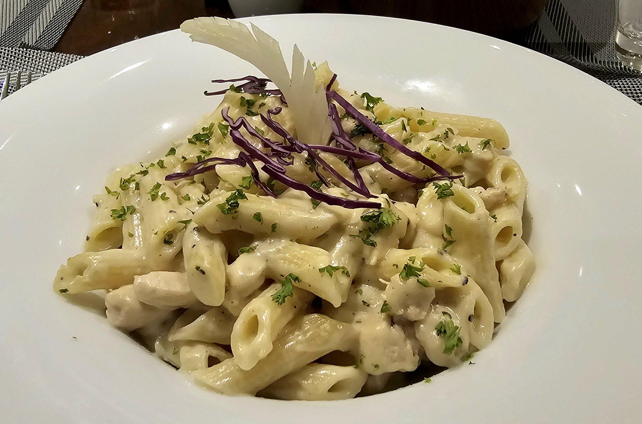 Phone photo of penne alfredo before editing